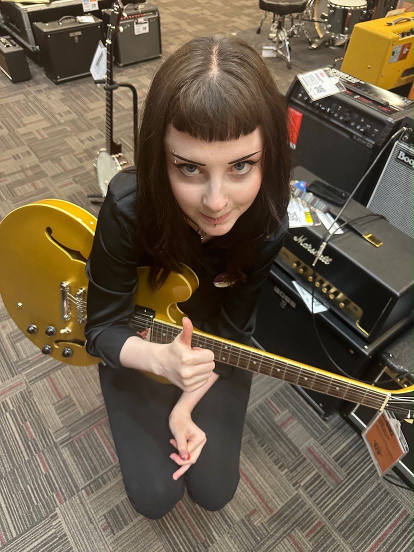 Portrait of Mikaila Palm with a guitar